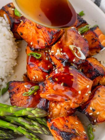 drizzling soy honey glaze over salmon bites