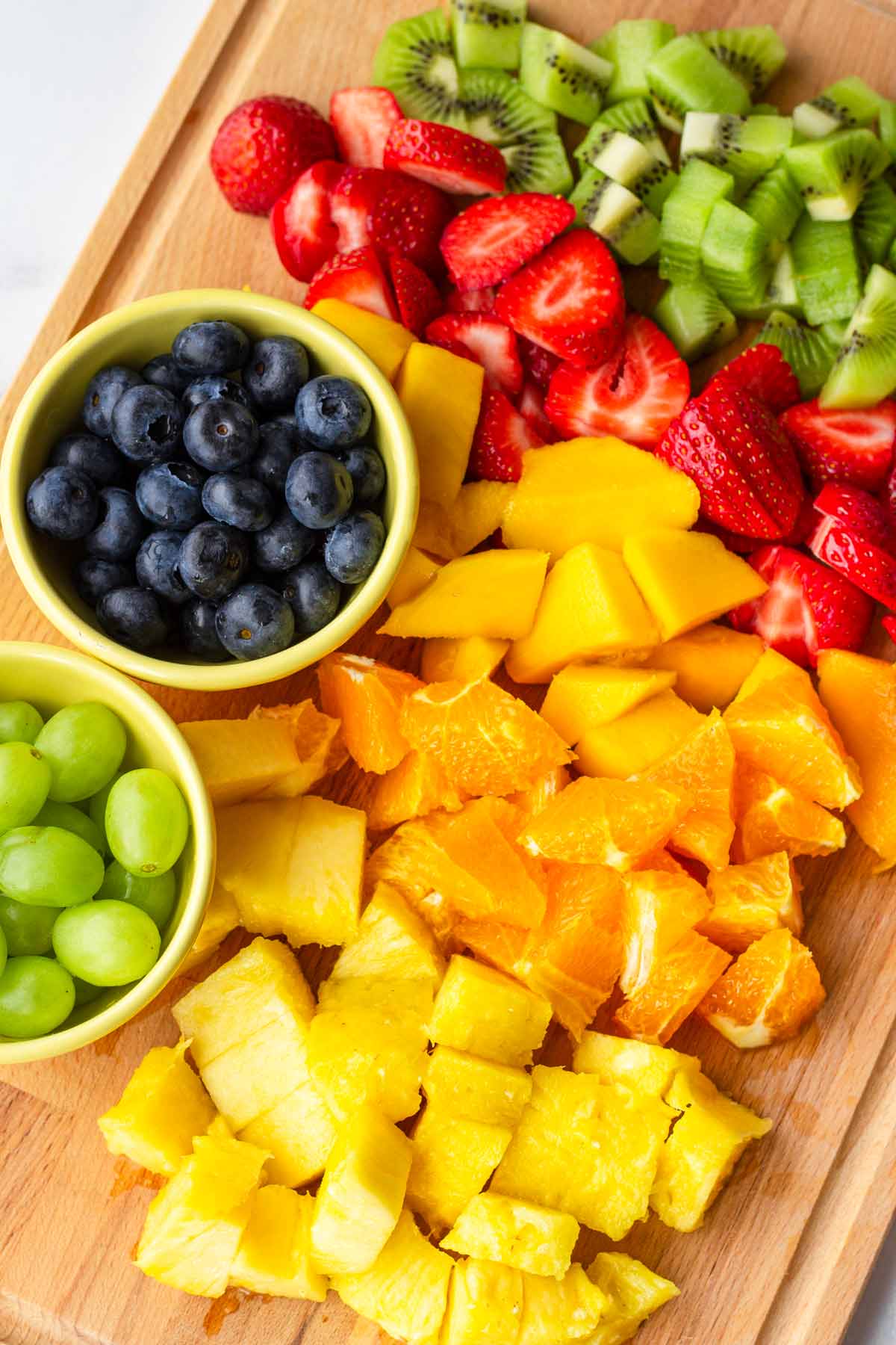cut up fruit in a wood cutting board