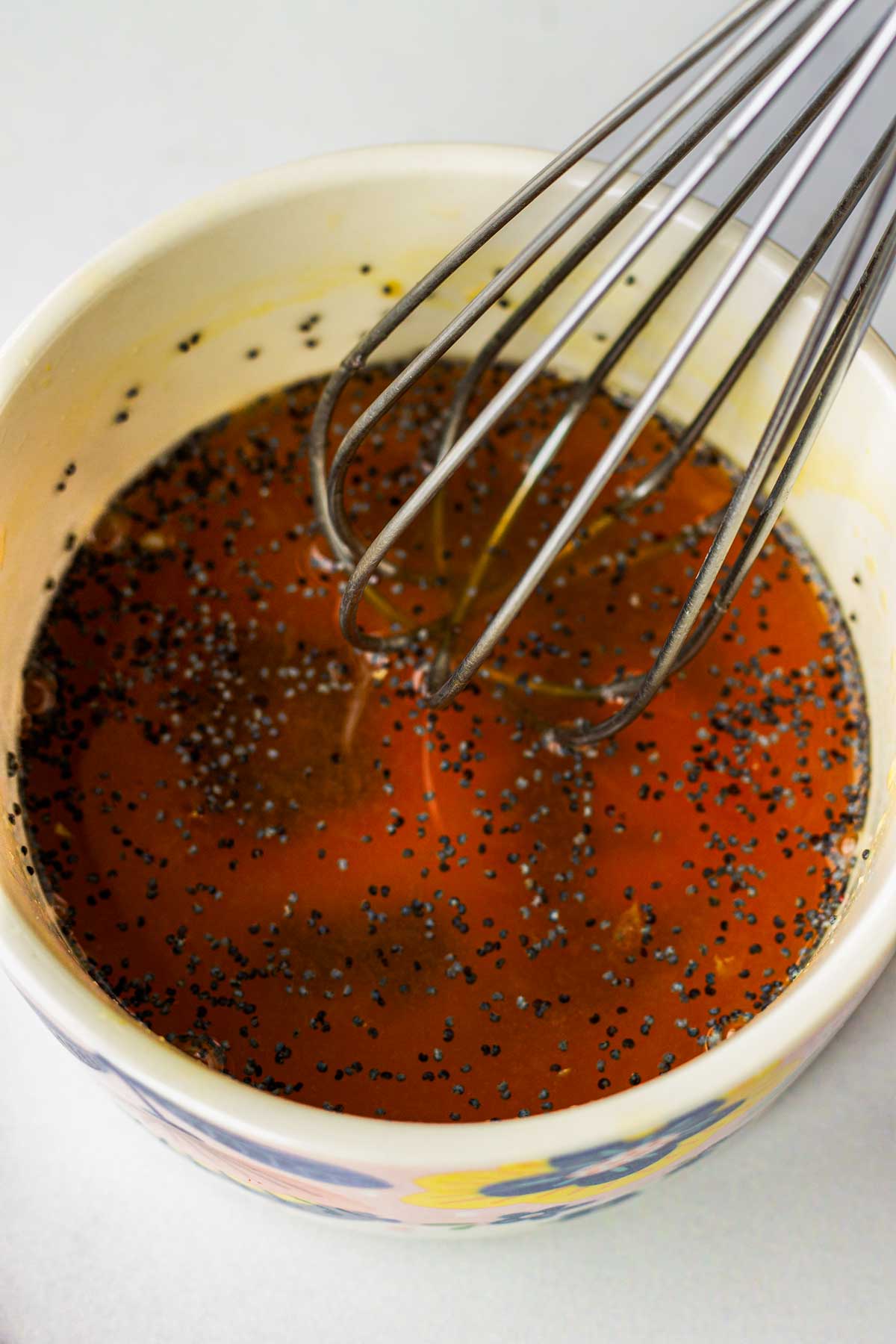 whisking the honey orange dressing