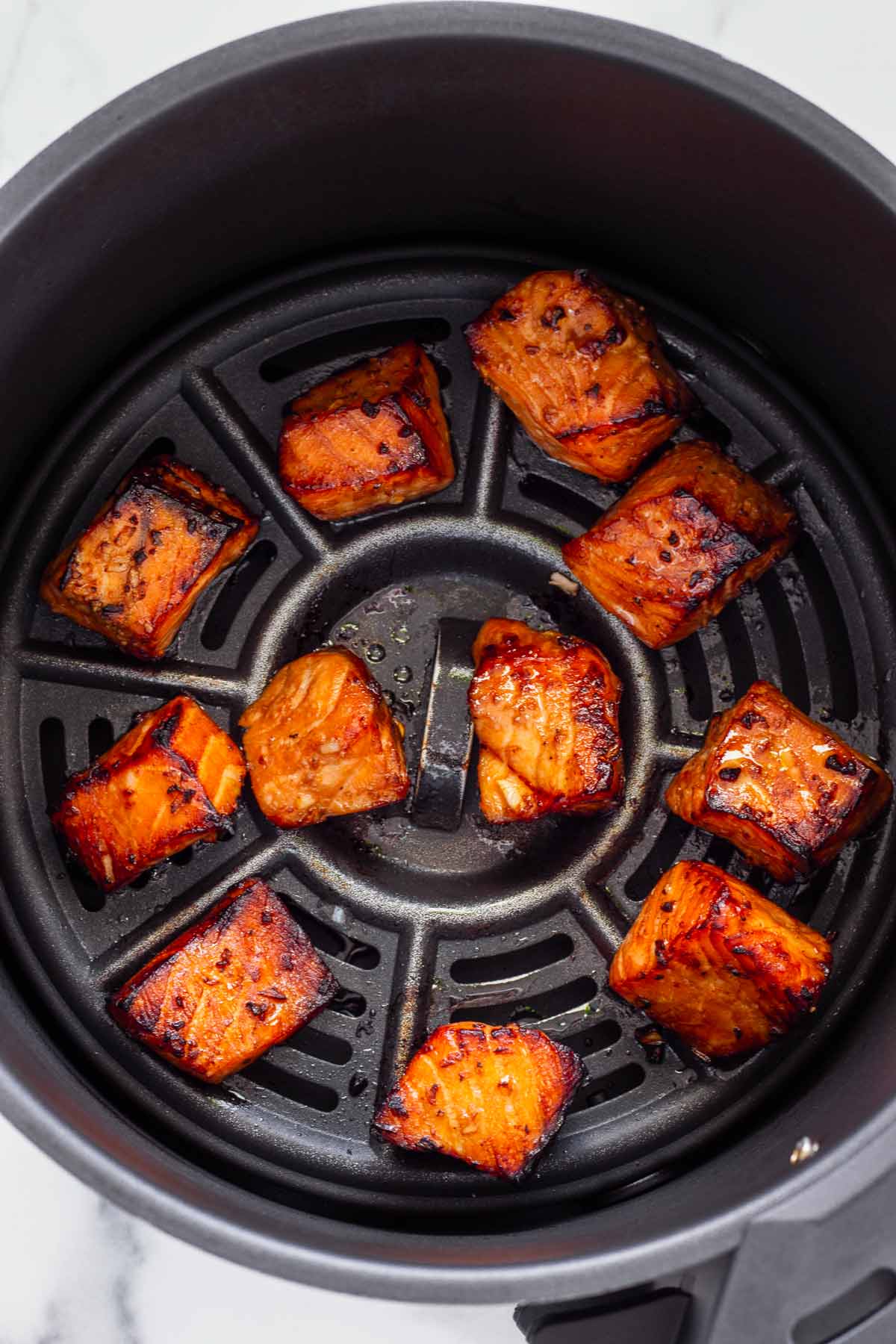 salmon bites cooked and caramelized inside air fryer
