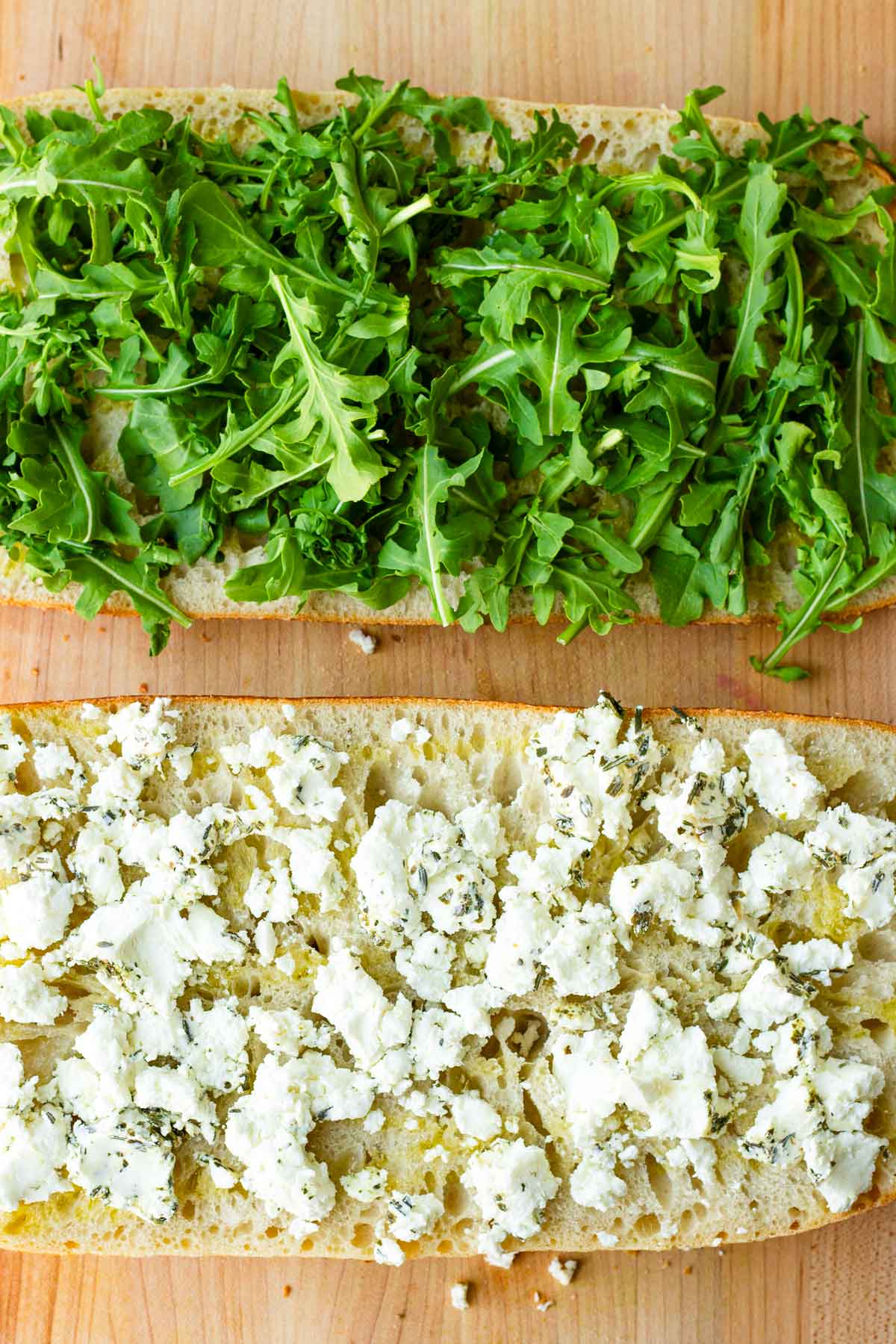 goat cheese and arugula spread on ciabatta bread halves