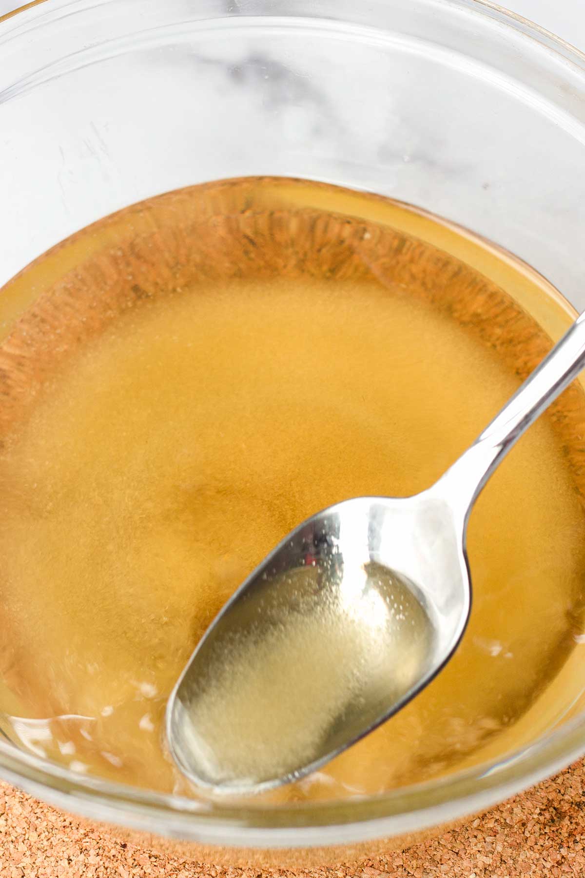 dissolving sugar with hot water in a bowl