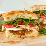 focaccia sandwich with turkey and fresh mozzarella, pesto, and toppings