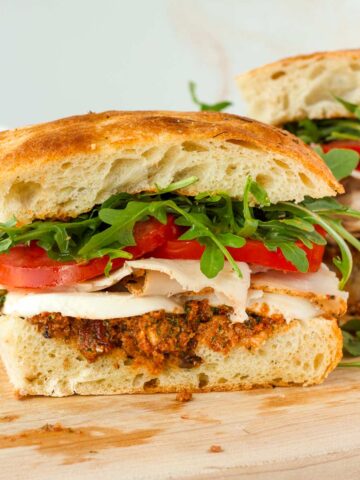 focaccia sandwich with turkey and fresh mozzarella, pesto, and toppings