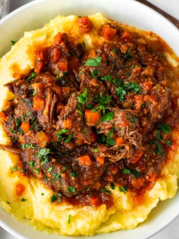 italian pot roast served over mashed potatoes in a bowl
