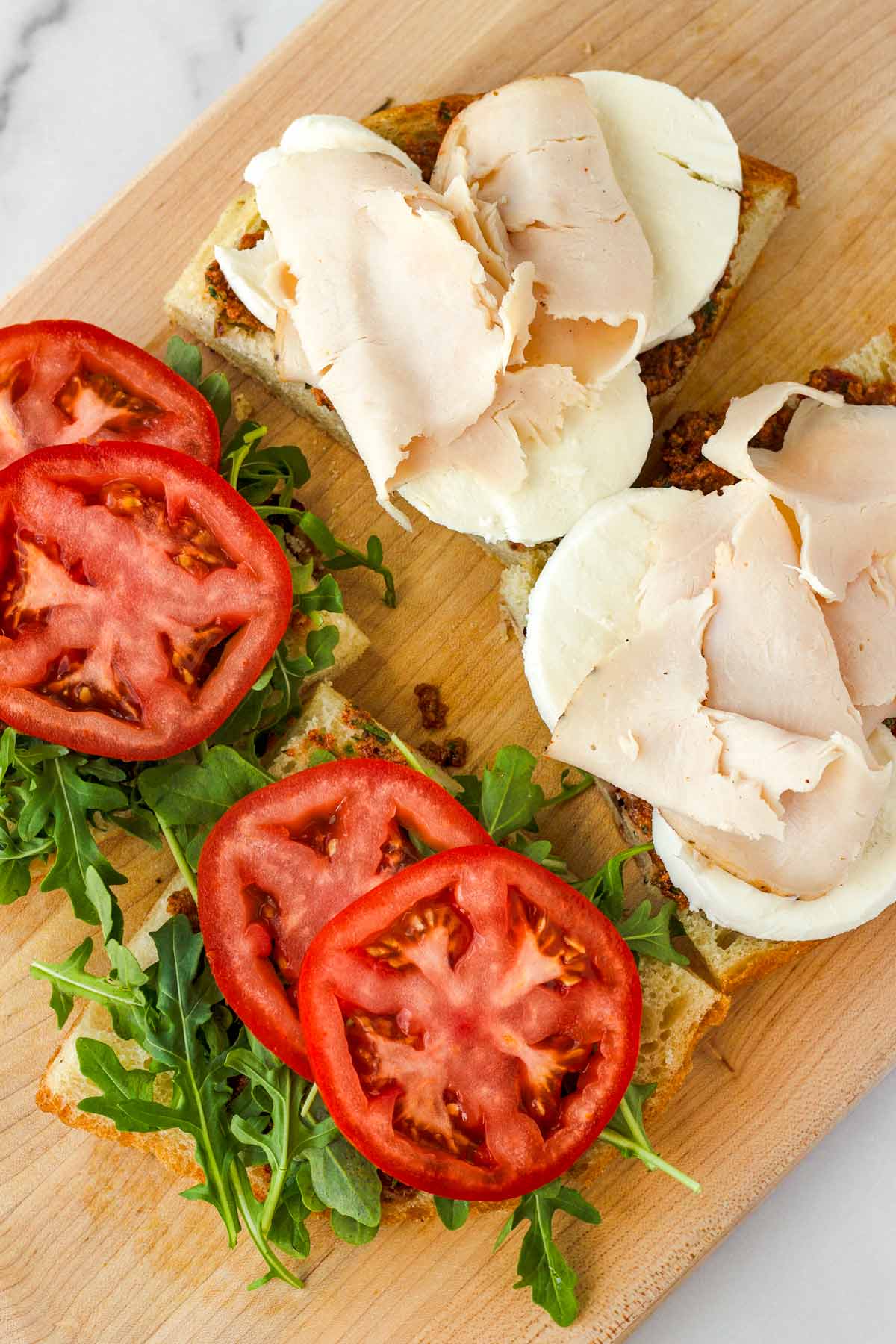 adding mozzarella and turkey on top