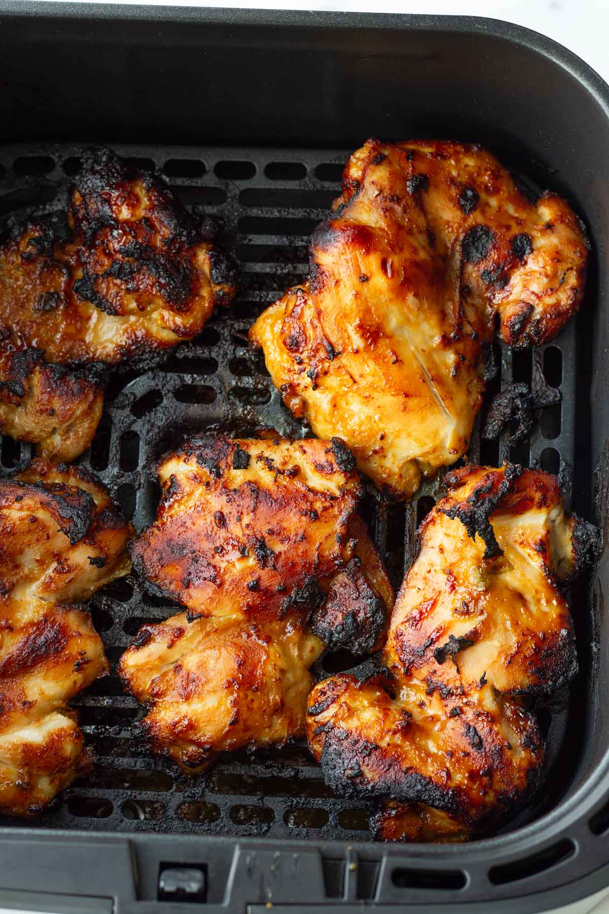 air fried lemon miso chicken thighs in air fryer basket