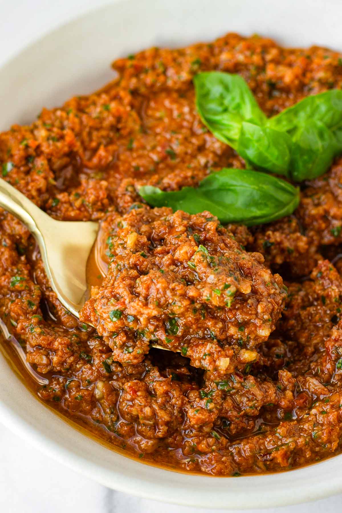 a spoonful of pesto from a bowl
