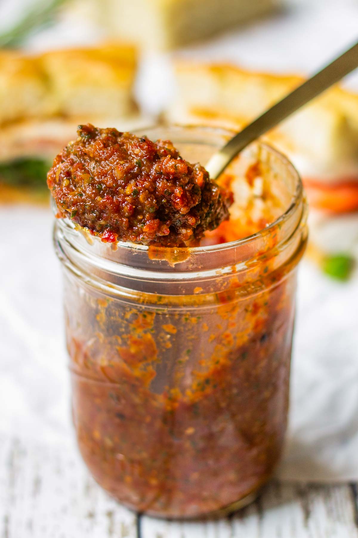 a spoonful of sun dried tomato pesto from mason jar