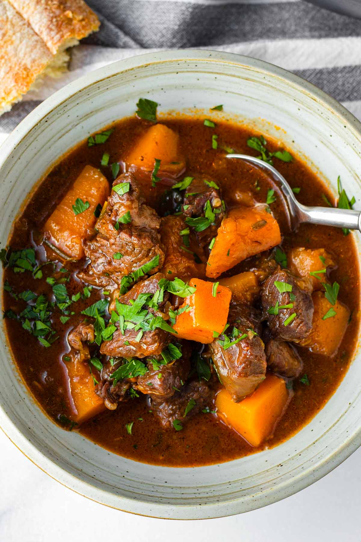 beef stew in bowl with a spoon