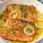 salmon piccata with capers and lemon slices on top