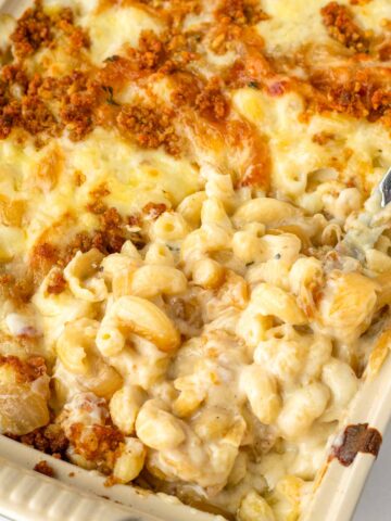 creamy french onion mac and cheese baked in a ceramic casserole