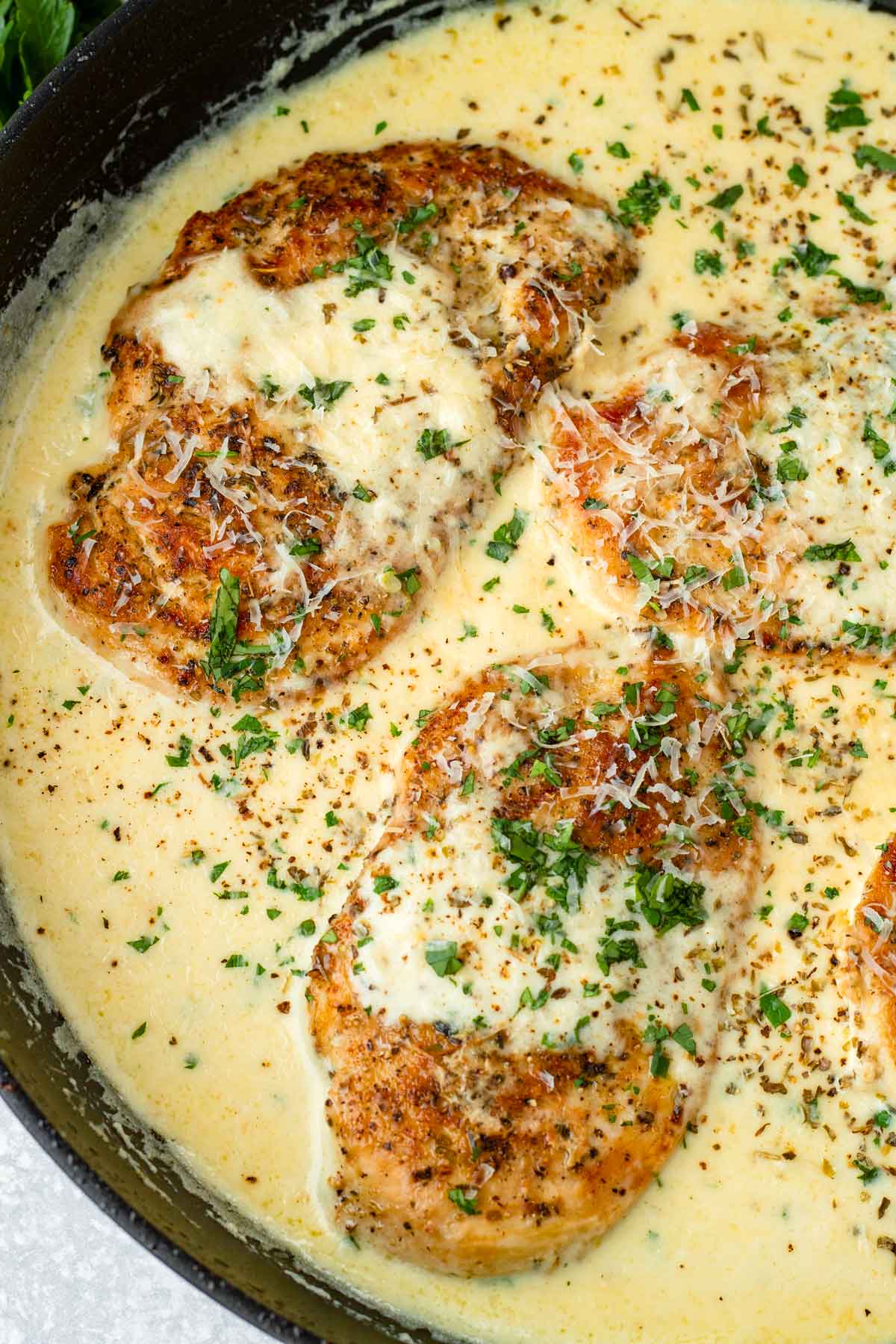 garnished creamy garlic parmesan chicken in the pan