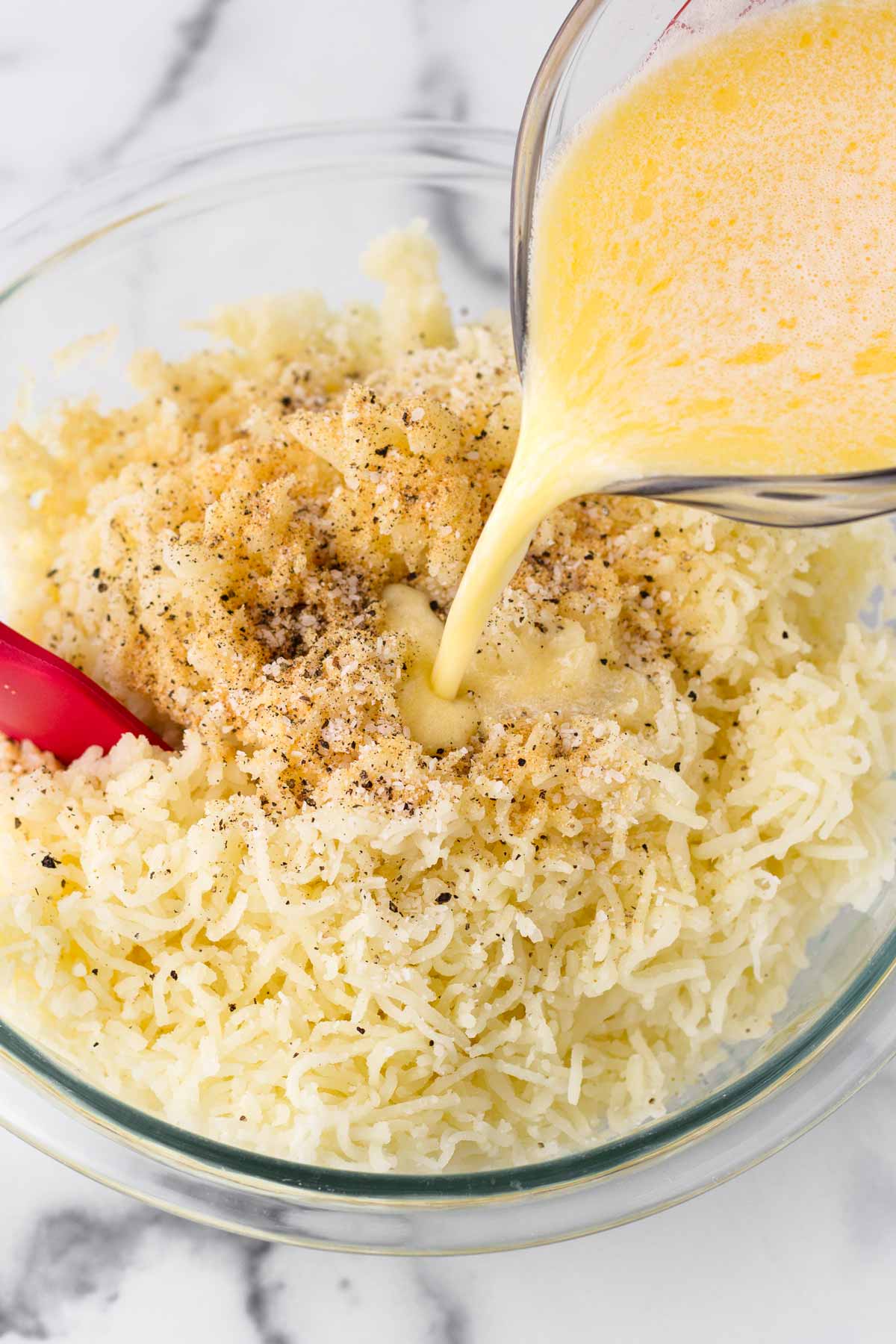 adding melted butter and dairy into the pressed potatoes