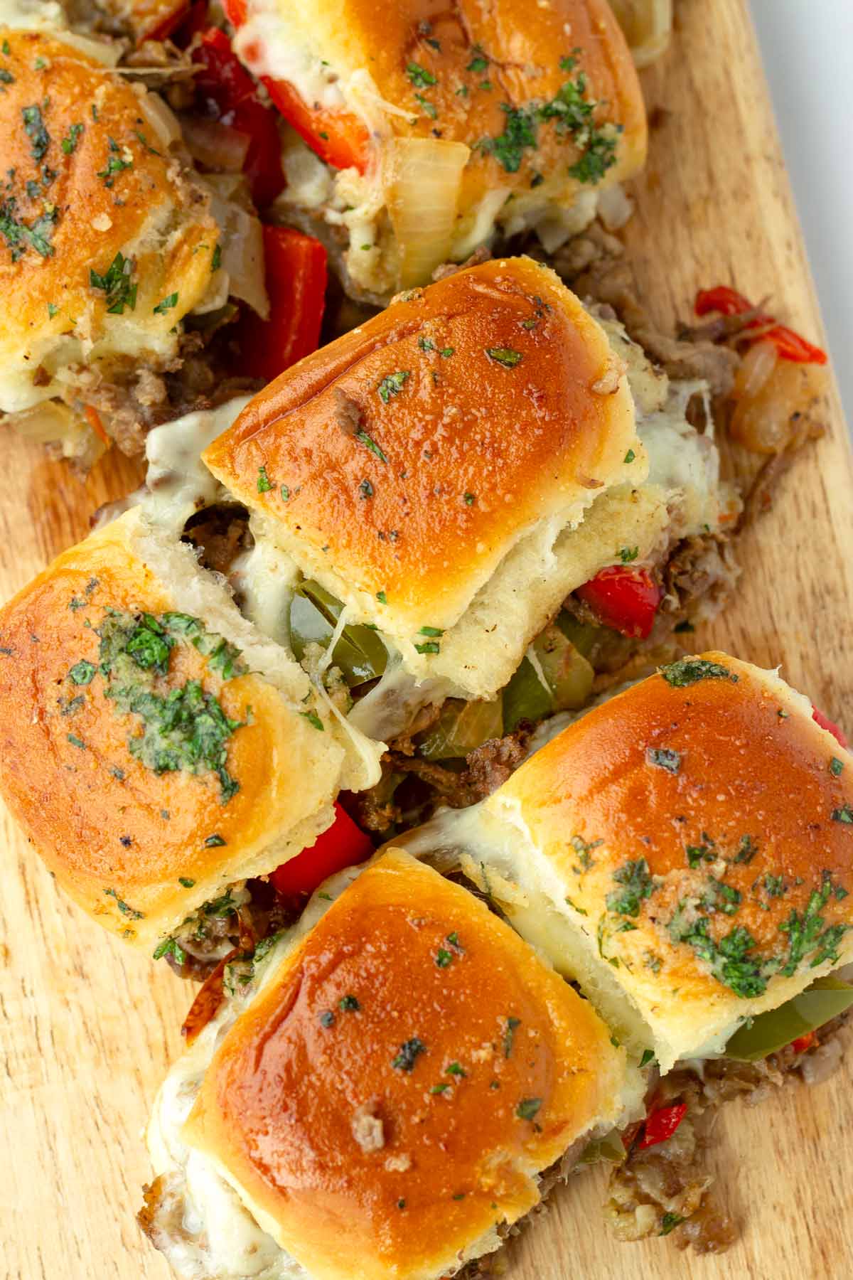 golden brown baked sliders with philly cheesesteak filling