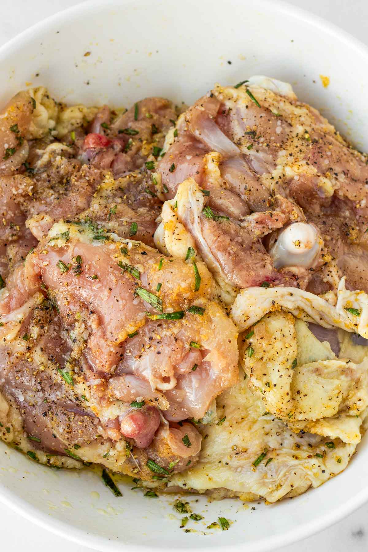 seasoned bone-in chicken thighs in a bowl