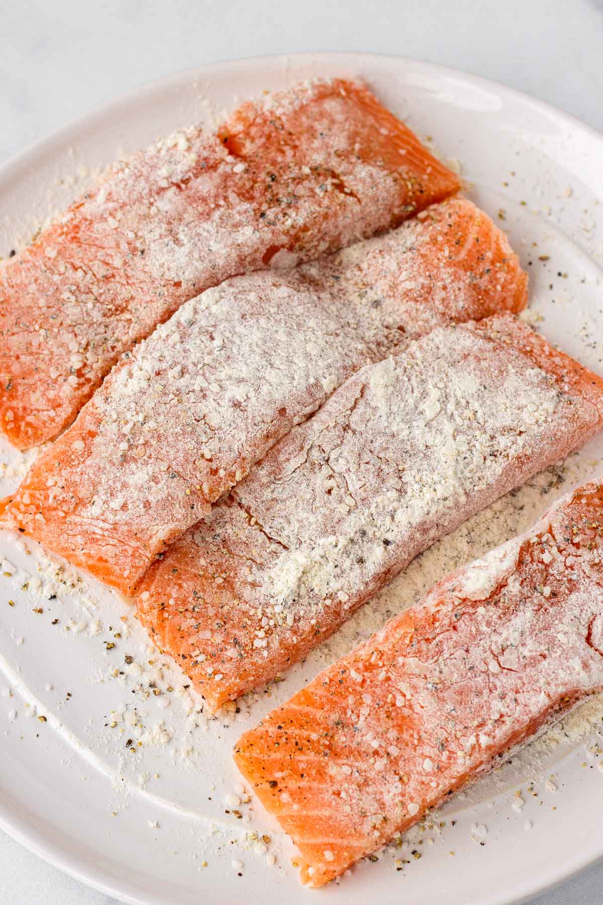 seasoned and lightly flour salmon before cooking