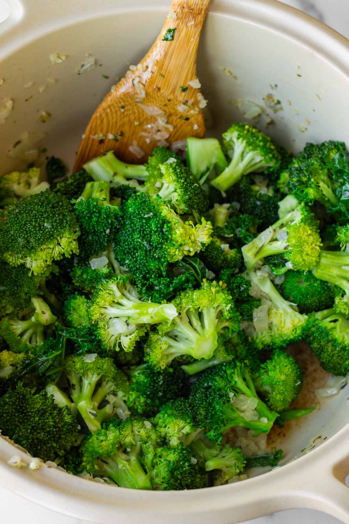 sauteing broccoli florets and kale in the pot