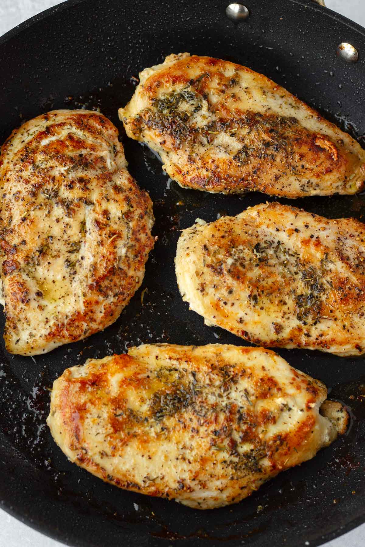 seared chicken cutlets in a skillet