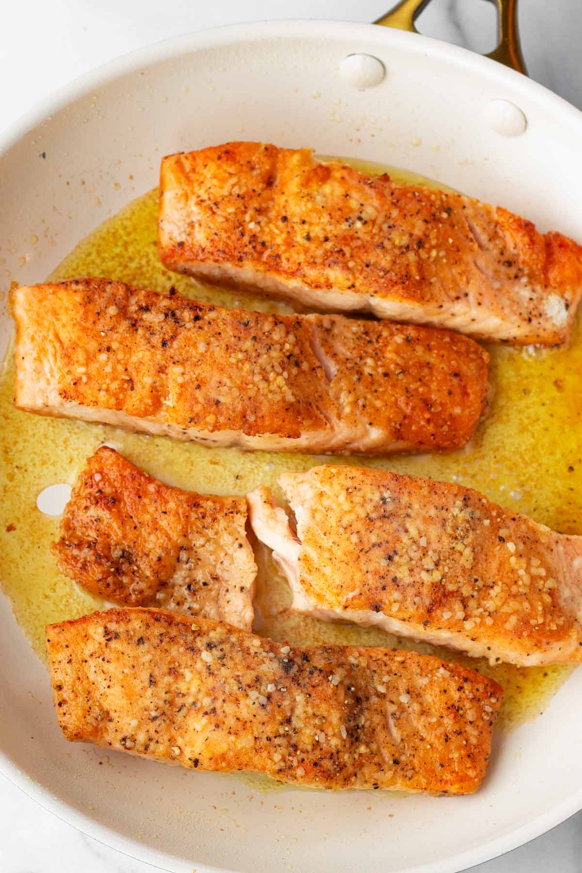 seared golden brown salmon in skillet