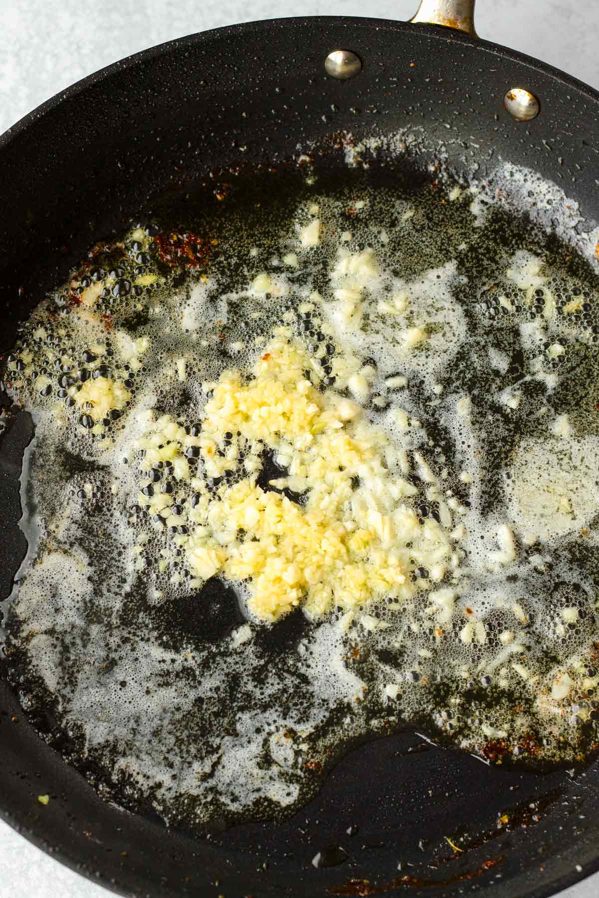 sauteeing garlic with butter in the skiller