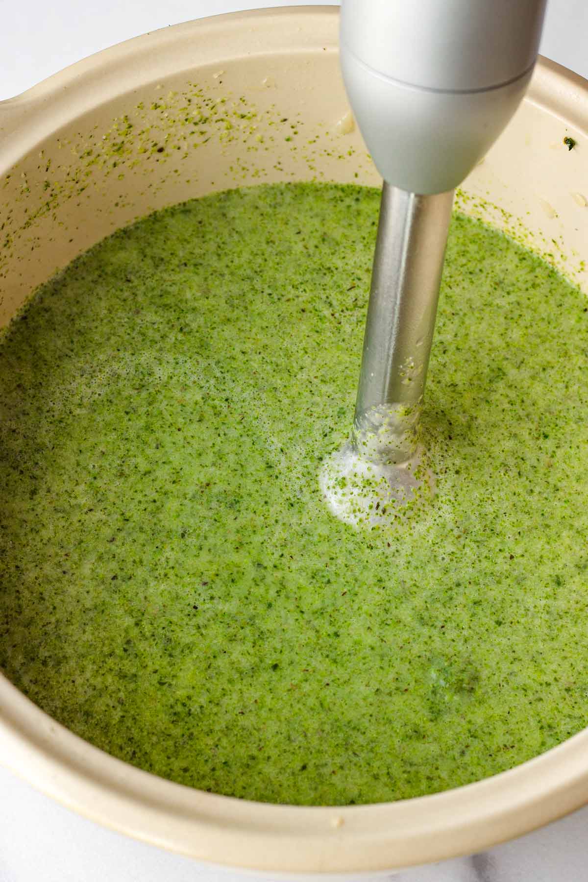 blending broccoli soup with immersion blender