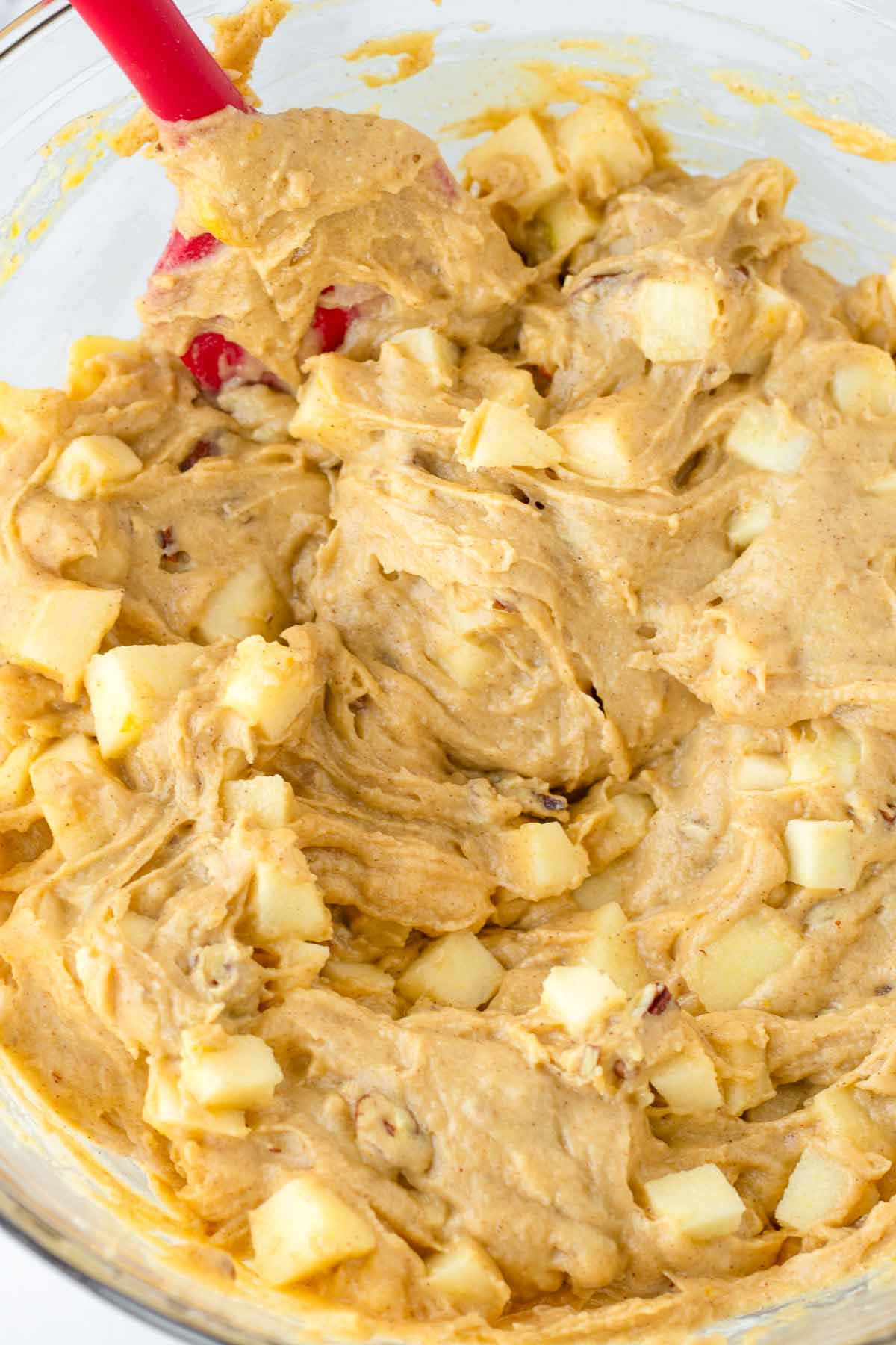 folding diced apples and pecans into the batter