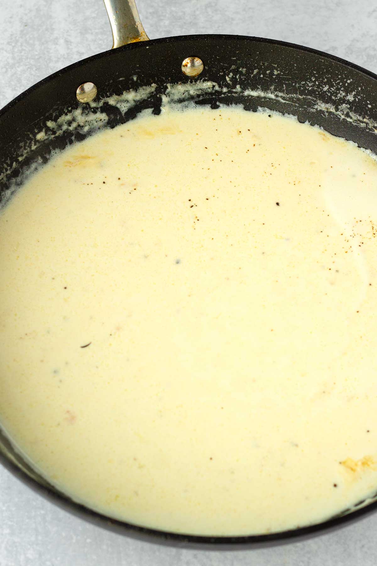 building the creamy garlic parmesan sauce in the skillet