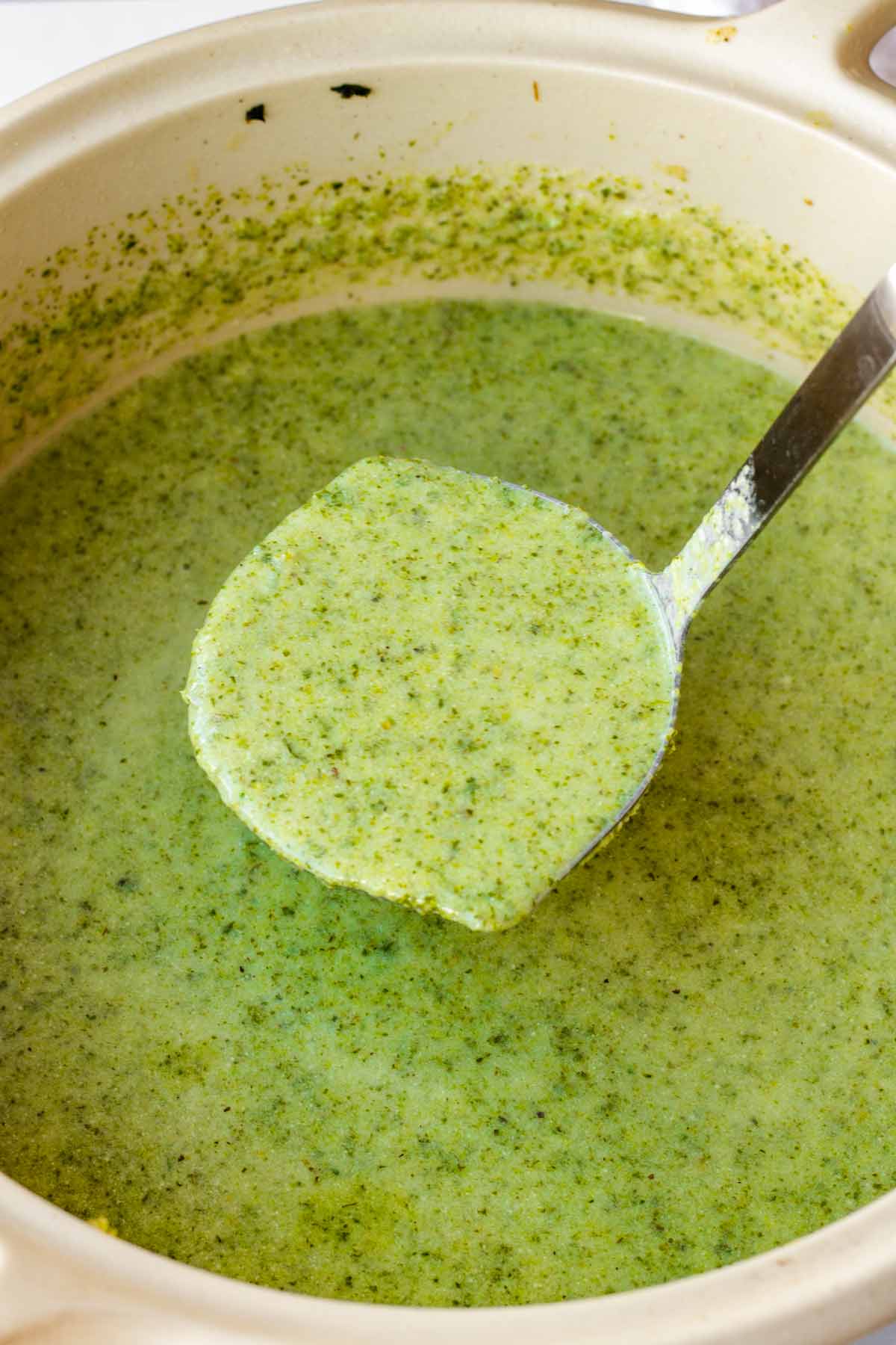 a ladle of broccoli soup