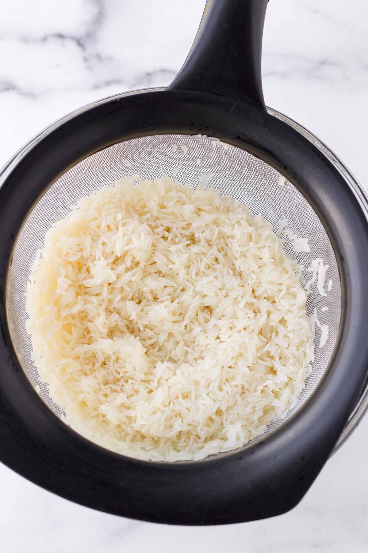 rinsing rice through a colander