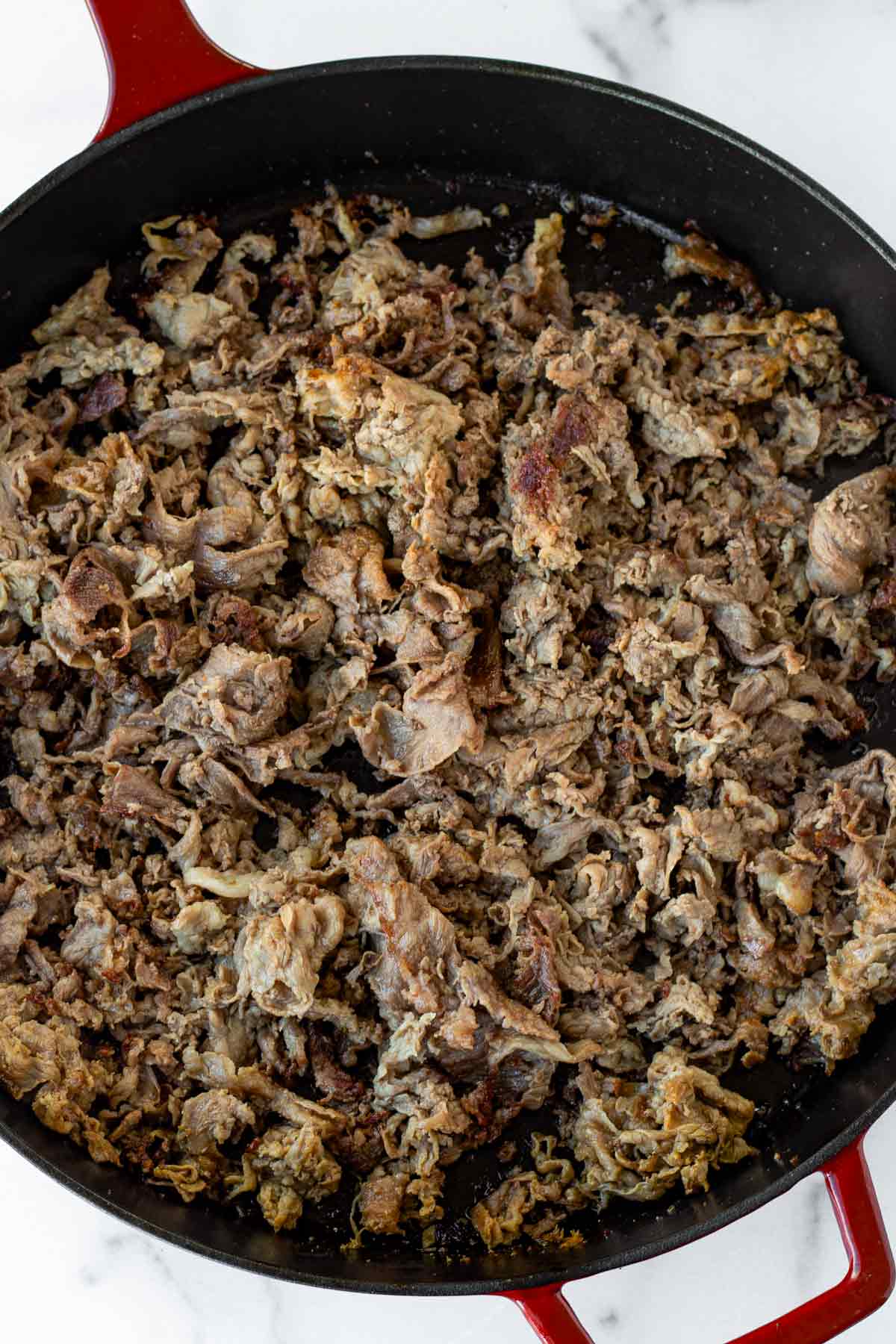 cooking shaved steak in a cast iron skillet