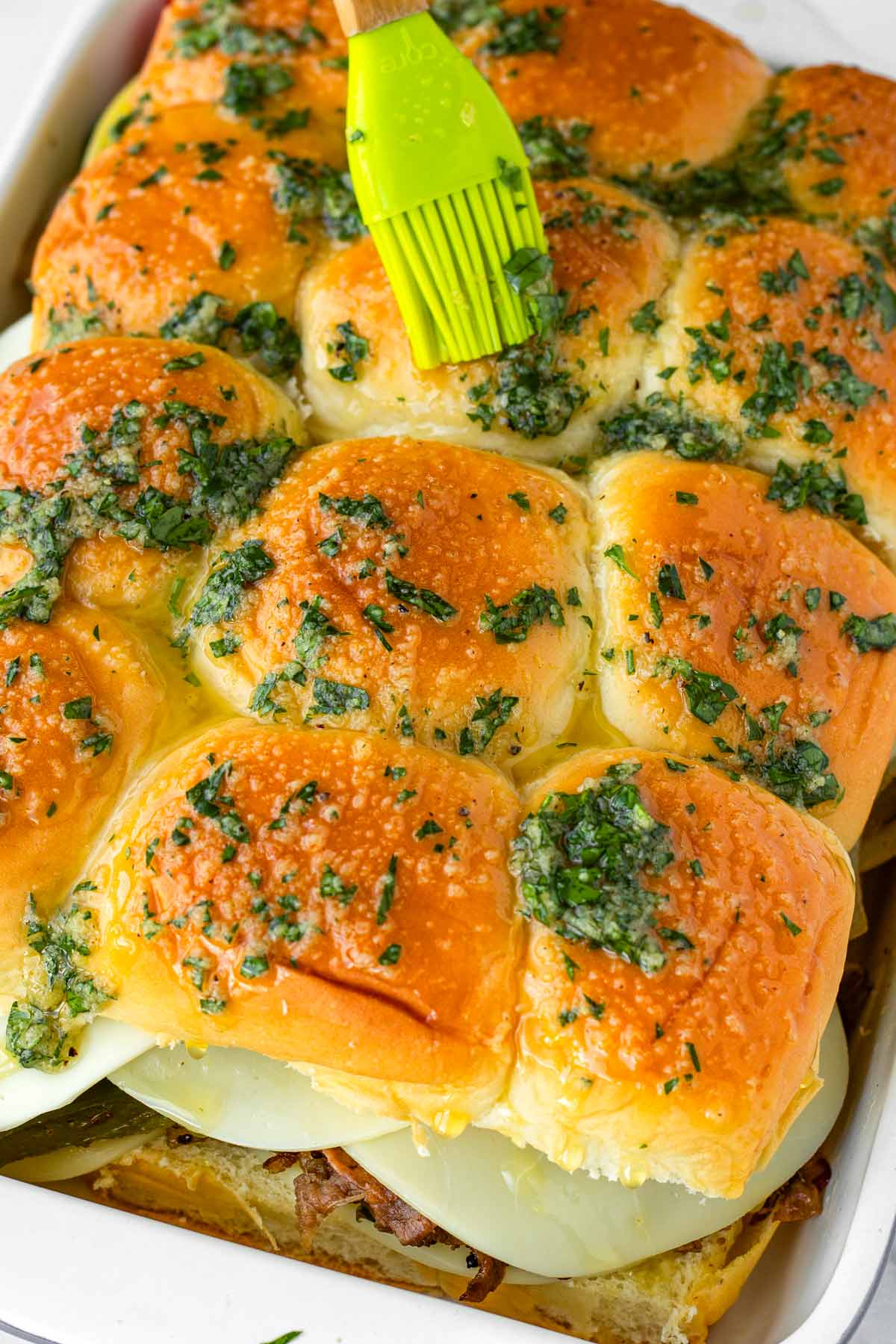 brushing the tops of the buns with herbed garlic butter