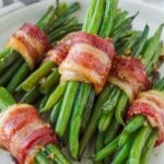 stacked bacon wrapped green bean bundles with brown sugar glaze