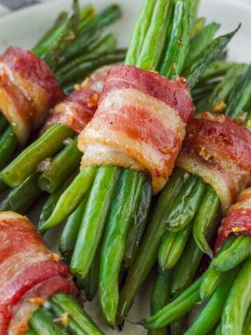 stacked bacon wrapped green bean bundles with brown sugar glaze