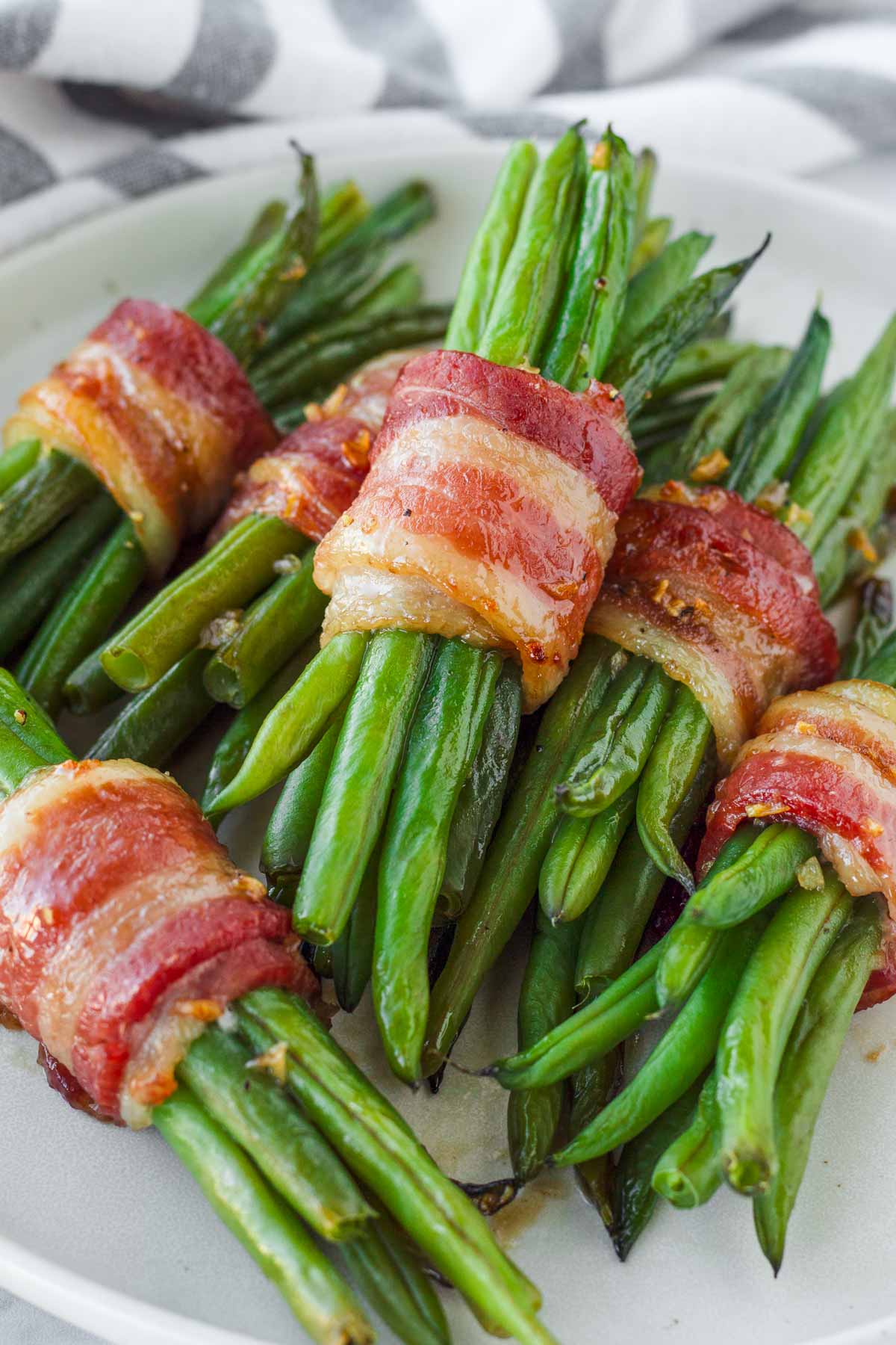 stacked green bean bacon bundles in a plate