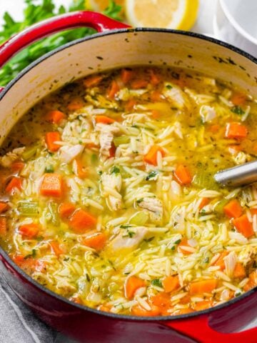 turkey orzo soup in a red dutch oven