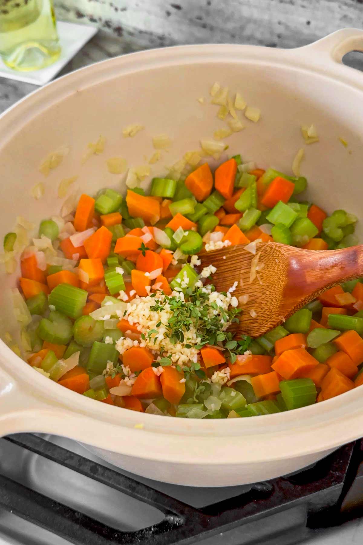 adding garlic and herbs to the vegetables