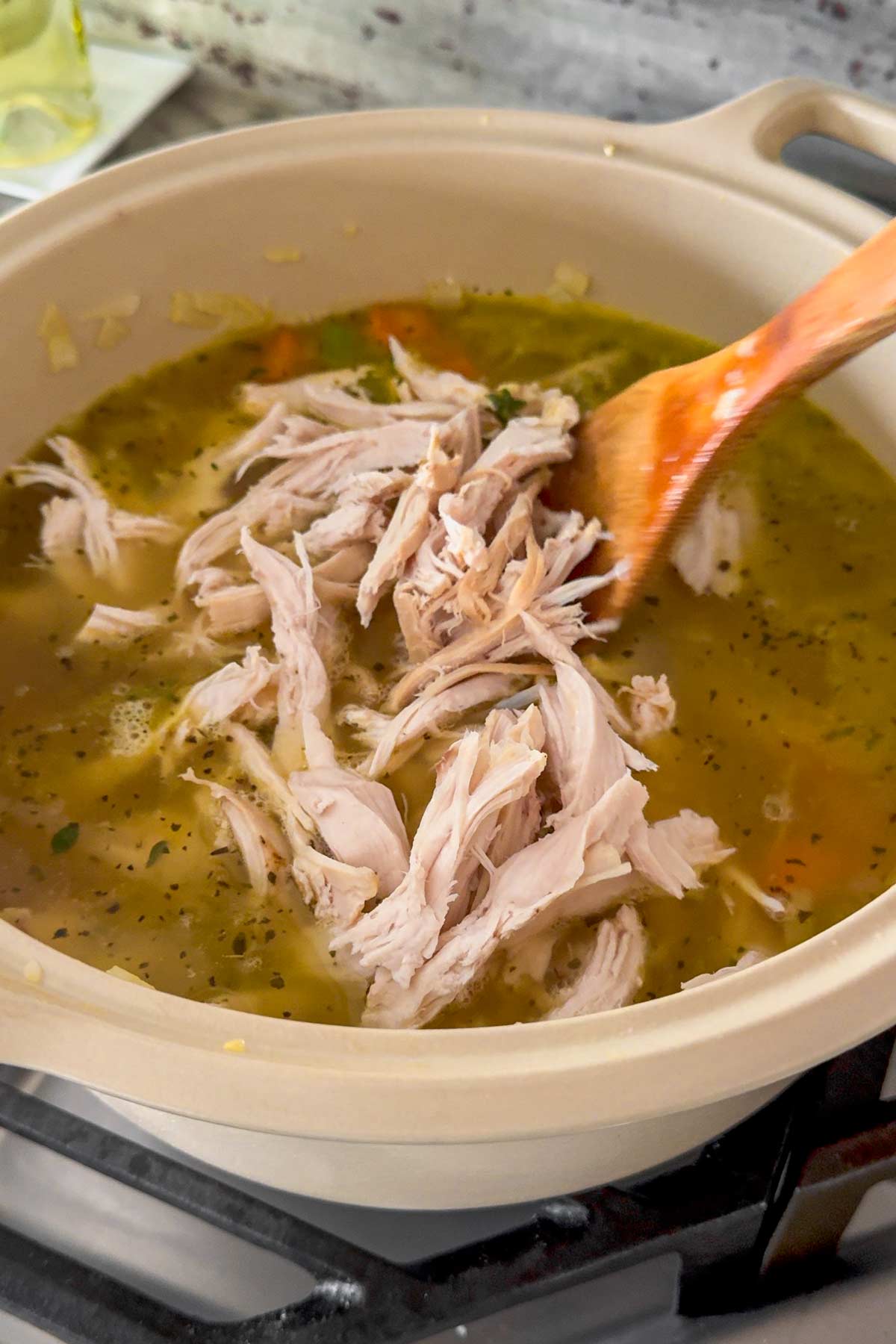 adding shredded turkey into the pot
