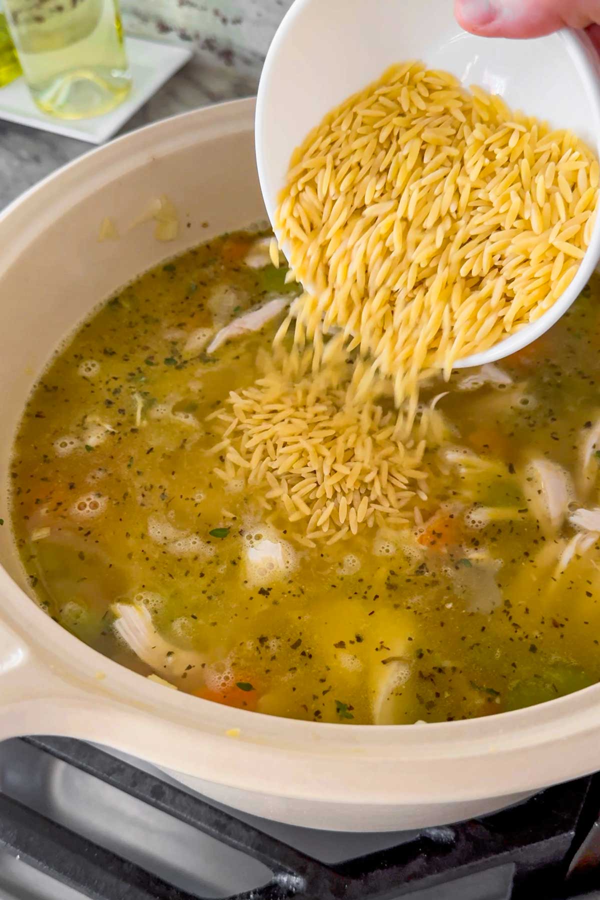 adding orzo to the soup