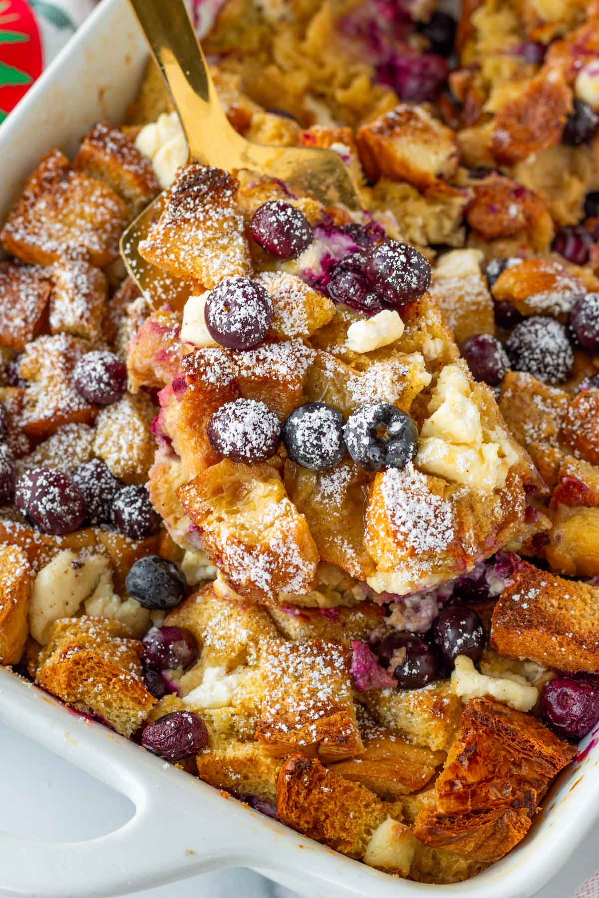 a spoonful of blueberry cream cheese french toast casserole from the pan