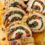 sliced stuffed pork tenderloin with prosciutto, spinach, tomatoes