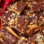 pieces of graham cracker toffee with almonds piled up together