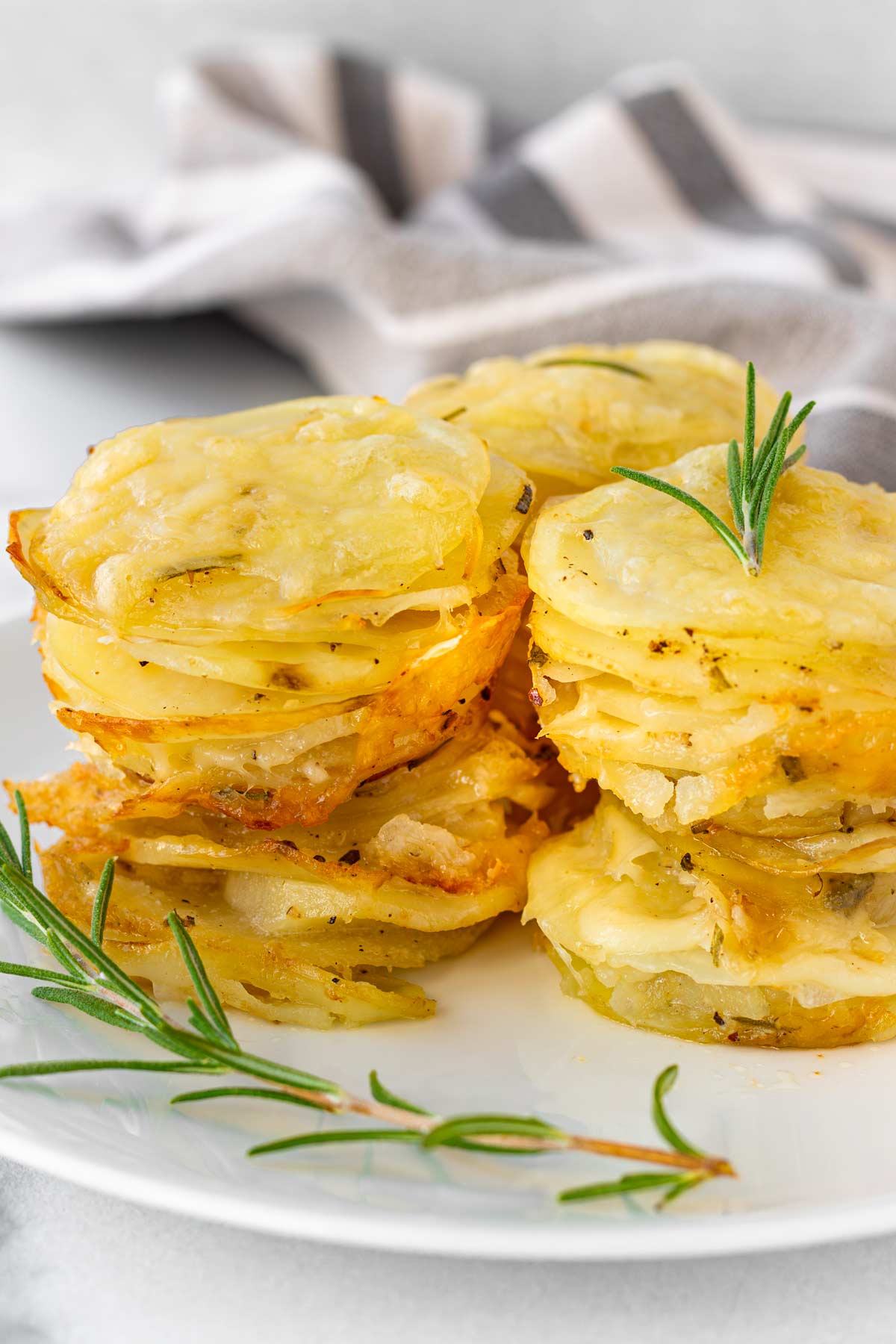 baked muffin tin stacked potatoes on plate