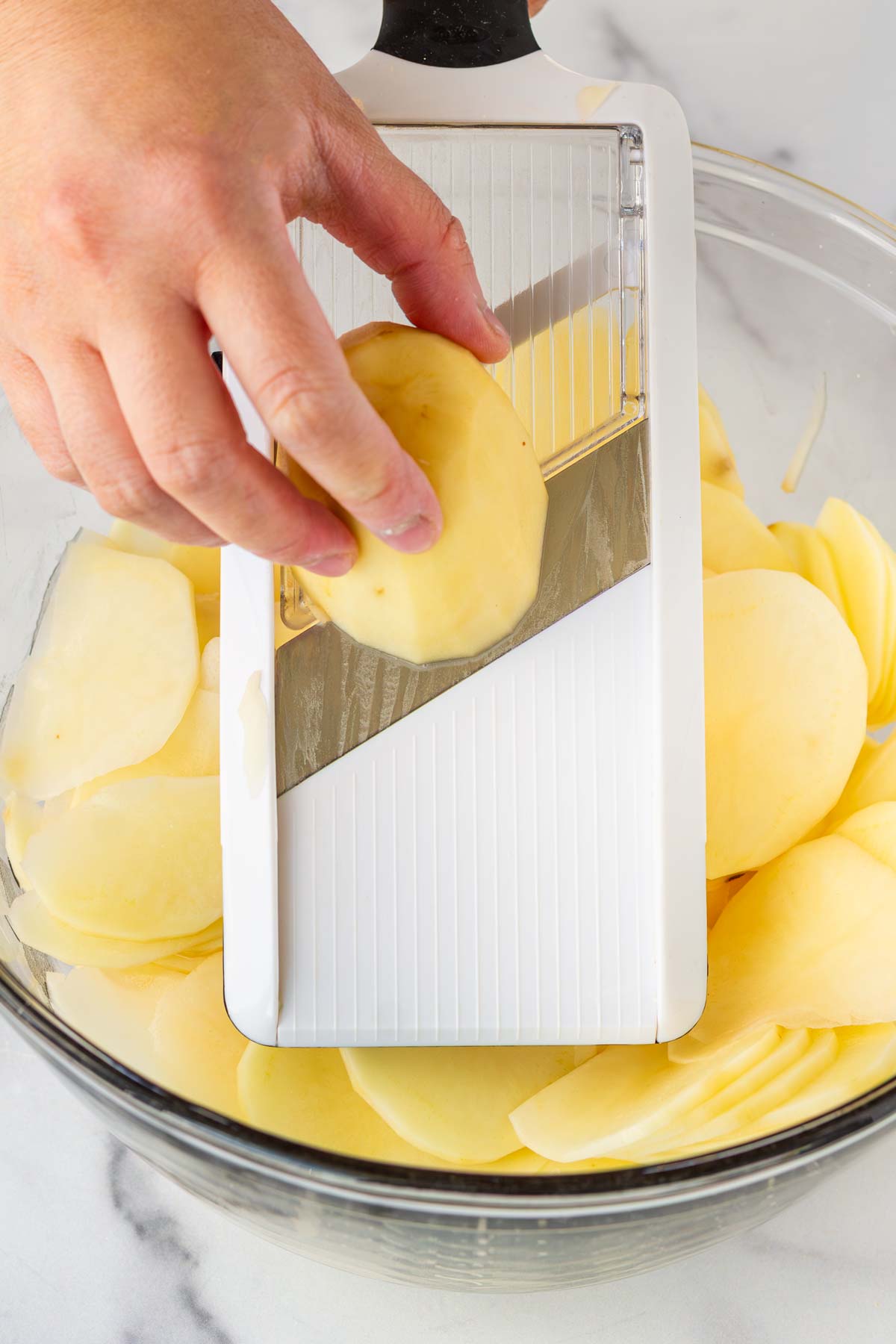 slicing potatoes with a mandoline