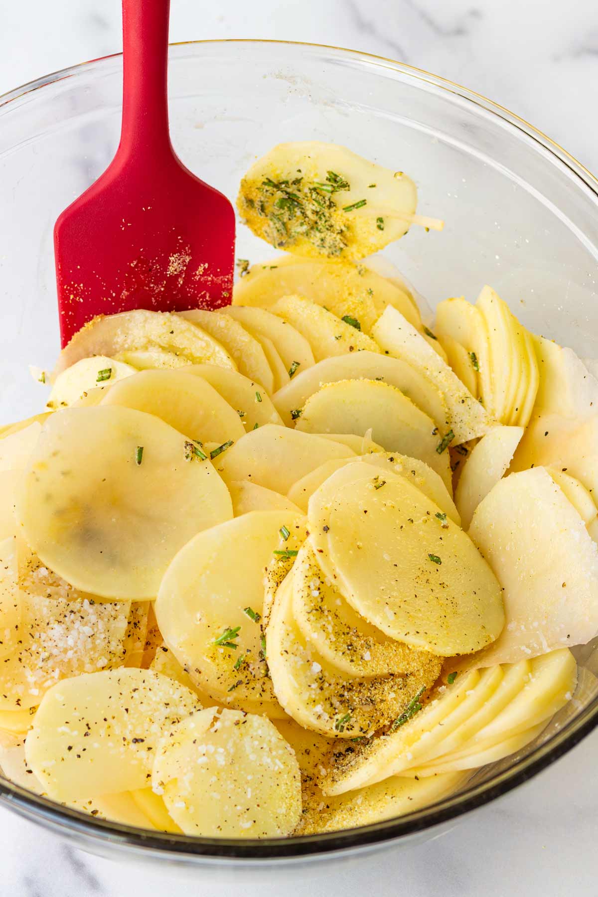 tossing potatoes with seasoning