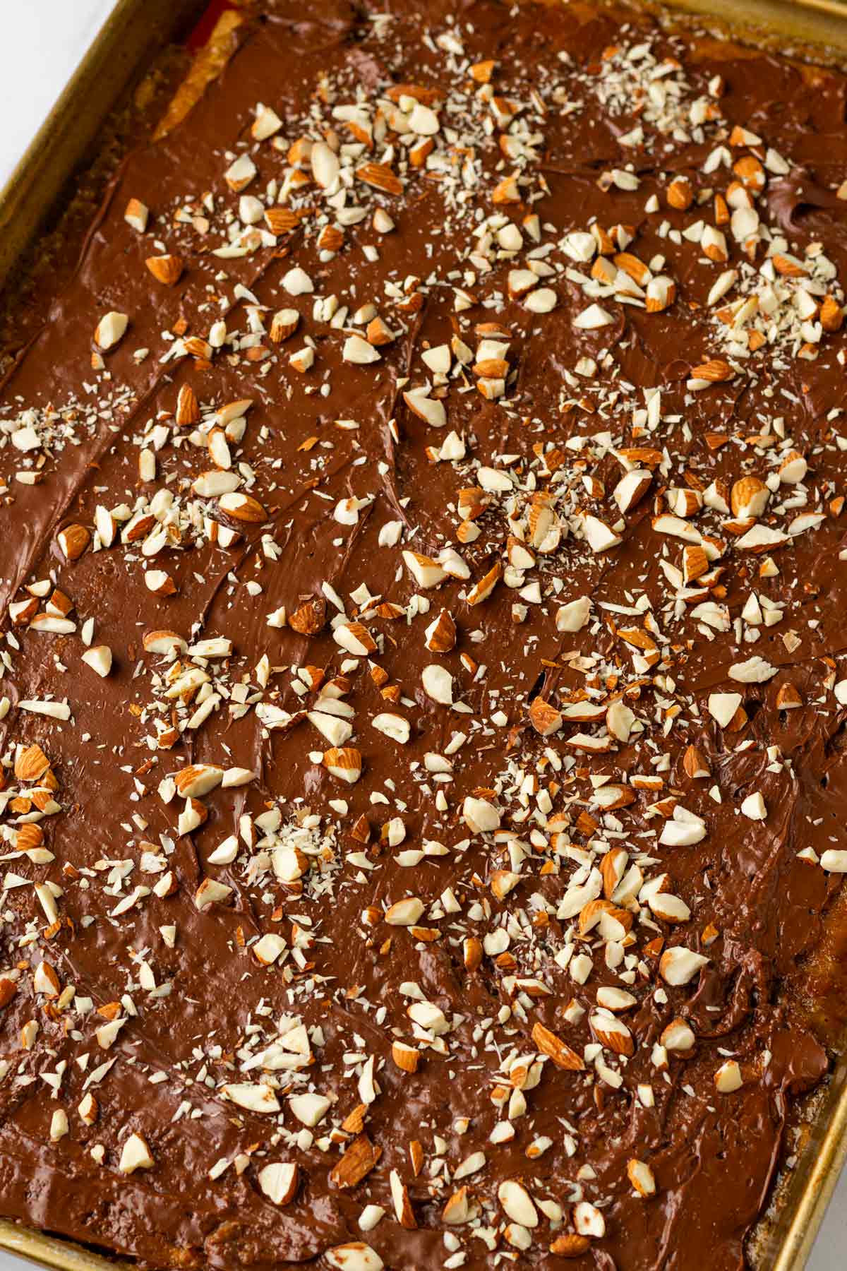 sprinkling almonds and sea salts on top of the graham cracker toffee layer