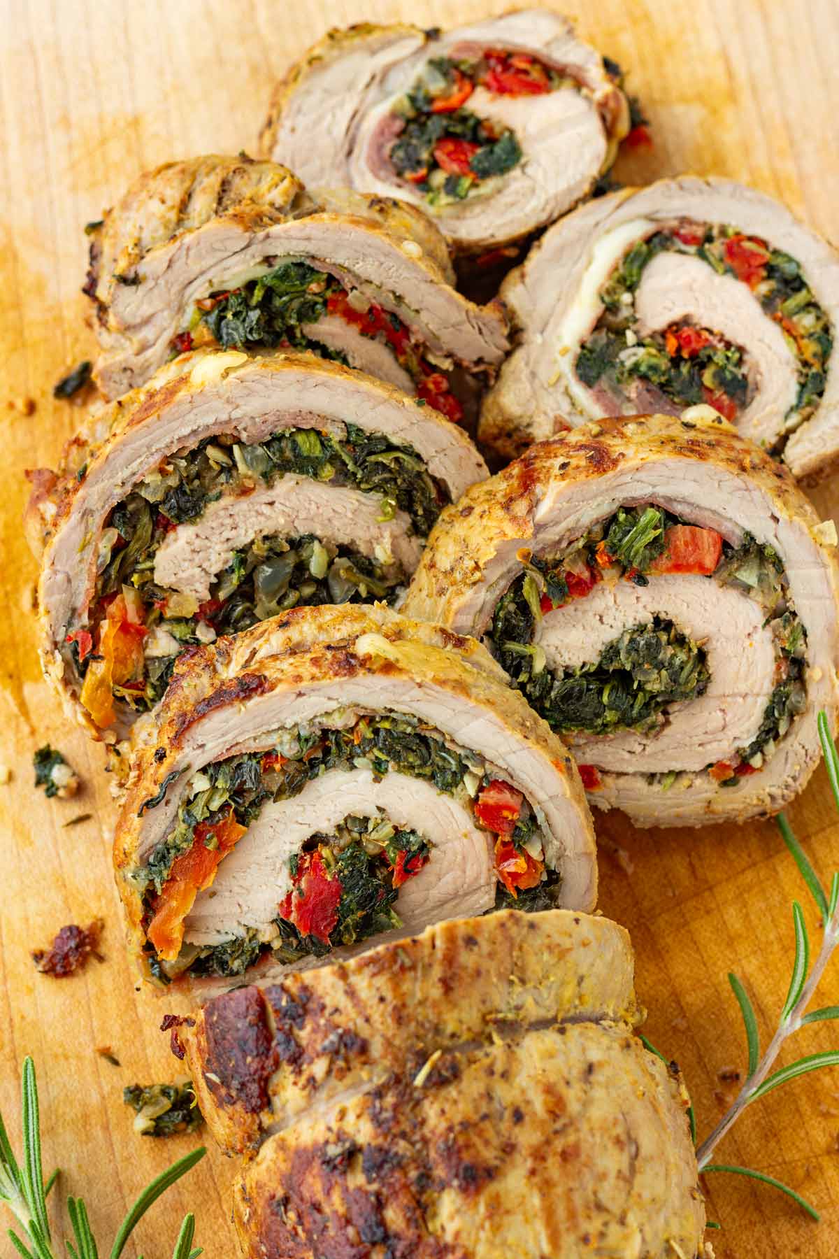 stuffed pork tenderloin sliced on cutting board