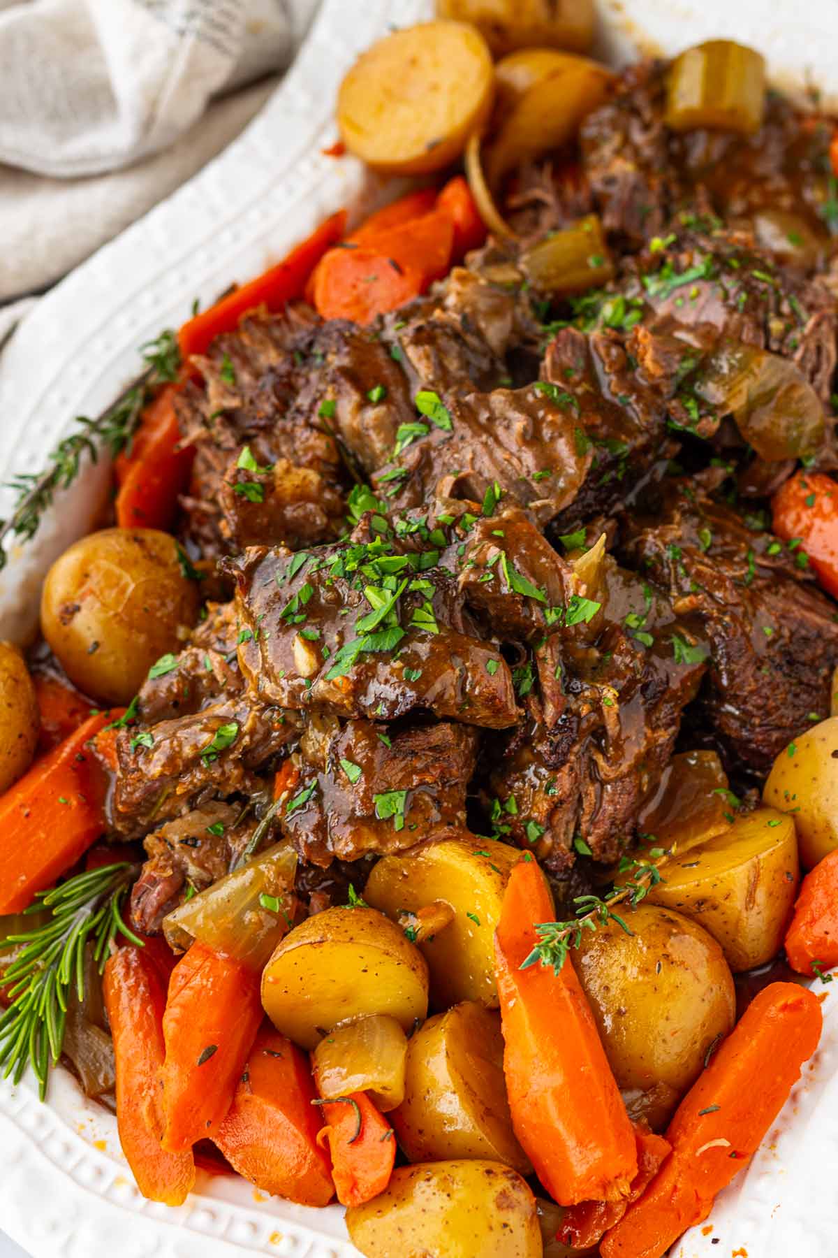 slow cooker pot roast served in a platter with herbs