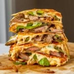 steak quesadillas stacked on top of each other