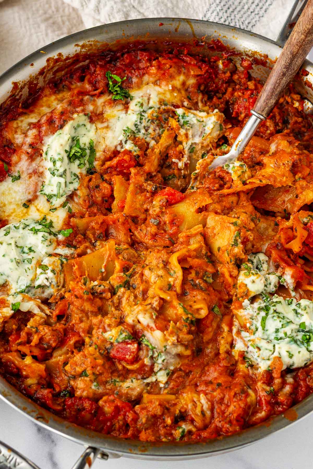 skillet lasagna layer with dollops of ricotta with basil